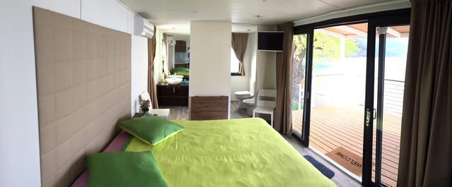 Modern hotel room with bright green bedding, perfect for retreats and meetings.
