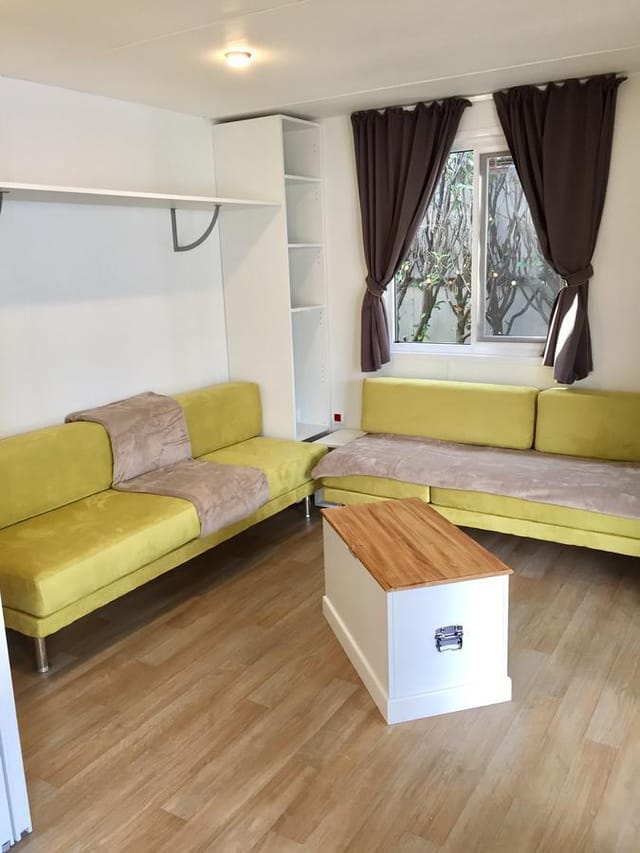 Cozy hotel meeting room with yellow couches for creative brainstorming sessions.