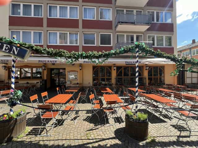 Outdoor event space at Paulaner Hotel with arranged tables for gatherings and meetings.