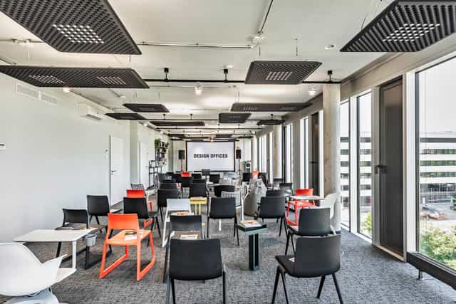 Modern conference room with colorful chairs at Villa Westend Hotel for meetings and workshops.