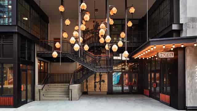 Modern Ace Hotel Brooklyn lobby with sleek staircase, ideal for events and meetings.