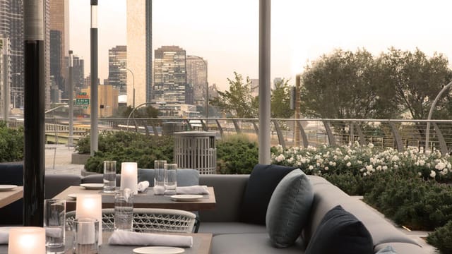 Stylish outdoor bar area in Riverpark with sleek furniture, ideal for upscale events.