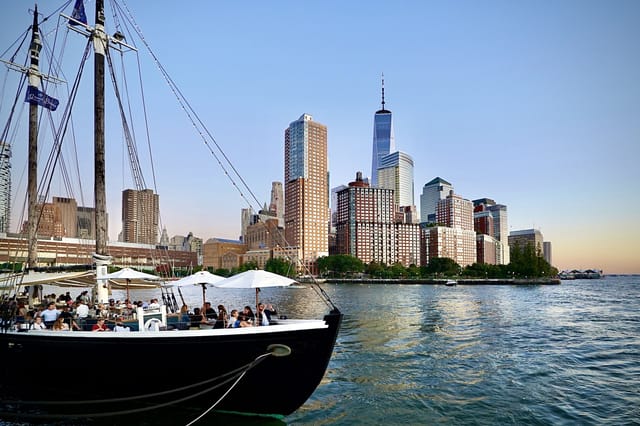"Riverpark waterfront bar with city skyline, ideal for corporate events and receptions."