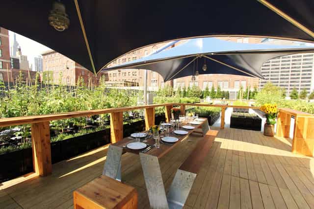 Outdoor dining setup at Riverpark venue, surrounded by lush greenery for events.