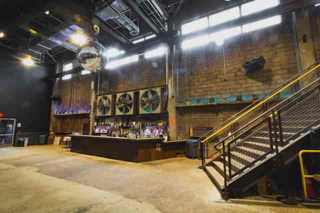 Brooklyn Steel concert hall with exposed brick, perfect for corporate and festive events.