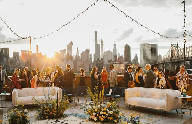 Elegant rooftop event space with skyline backdrop, ideal for networking and social events.