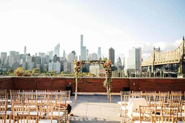 Rooftop wedding venue at The Bordone LIC with skyline view and floral arch.