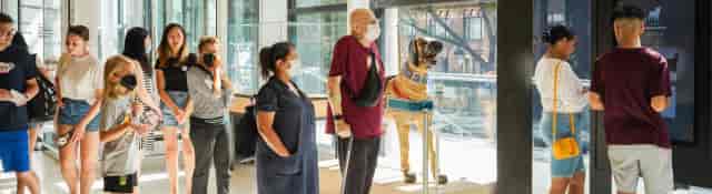 Interactive dog event at AKC Museum: diverse attendees in a modern venue.