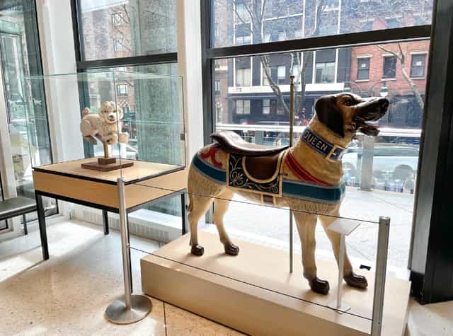 Exhibition of vintage carousel horse and dog statue at AKC Museum of the Dog.
