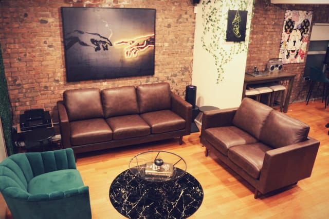 Rooftop lounge with leather seating, ideal for networking events and casual meetings.