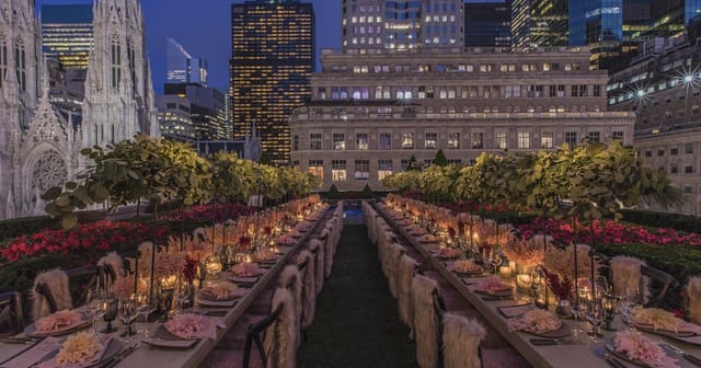 Elegant rooftop dining setup with city skyline, perfect for gala dinners and corporate events.