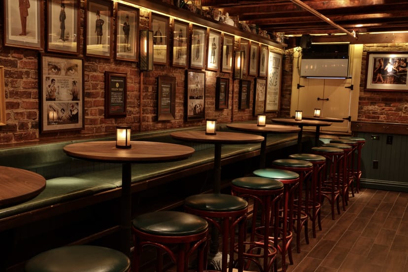 Cozy Cafe at The Dead Rabbit with brick walls, ideal for casual meetings and receptions.