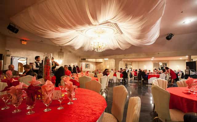 Elegant Rockaway Hall in Queens, featuring red linens and chandelier for formal gatherings.