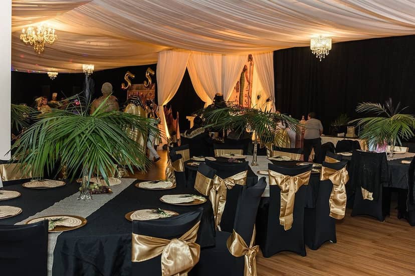 Rockaway Hall in Queens, elegant event space with black tables and gold accents, ideal for celebrations.