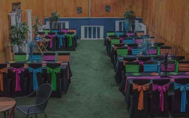 Vibrant Twilight Hall event space with colorful table settings for festive gatherings.