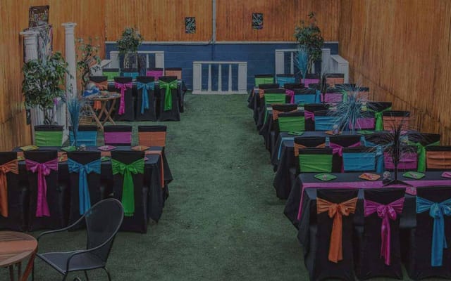 Vibrant Twilight Hall event space with colorful table settings for festive gatherings.