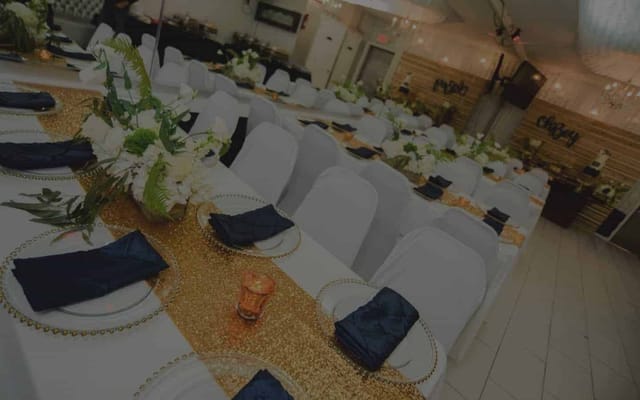 Elegant Twilight Hall setup with white chairs and gold accents for weddings and formal events.