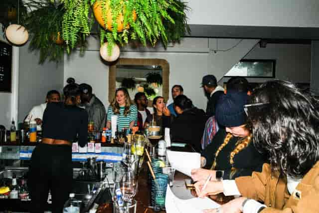 Vibrant wine bar gathering with guests, ideal for networking and casual meetups.