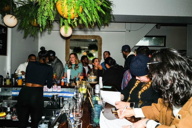 Vibrant wine bar gathering with guests, ideal for networking and casual meetups.