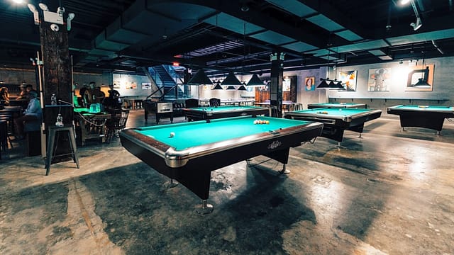 Bar at Sour Mouse NYC with pool tables for social gatherings and events.