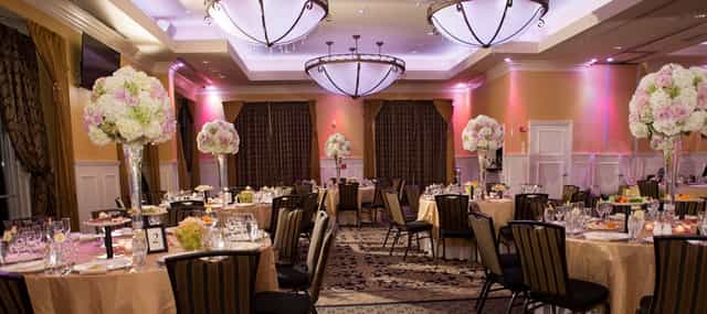 Elegant banquet hall for weddings and corporate events with chic floral centerpieces.