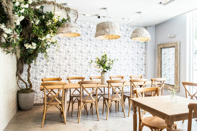 Elegant Maman restaurant meeting space with wooden furniture for intimate workshops.
