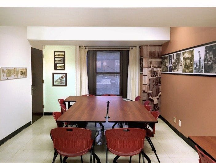 Versatile meeting space in Park Slope Library with red chairs for collaboration events.