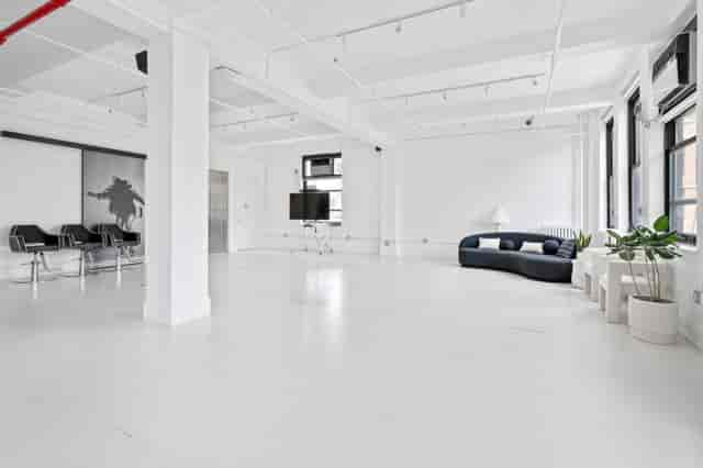 Modern event space in Garden House NYC with large windows, ideal for workshops and networking.