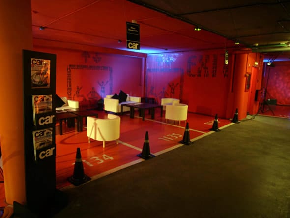 V&L Black event space at Puerta América Hotel with bold red walls for vibrant gatherings.