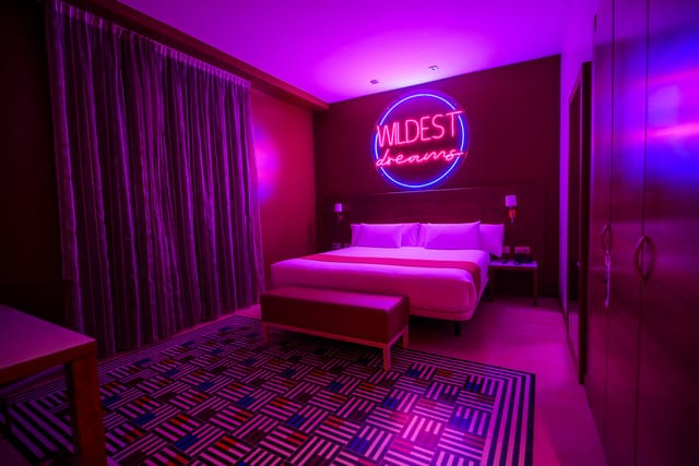 Modern hotel room at Hotel Gran Bilbao with vibrant lighting for networking events.