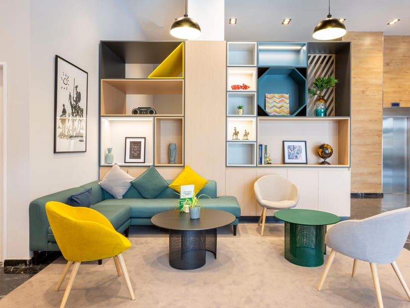 Modern lounge area at Holiday Inn Madrid, vibrant for networking and casual meetings.