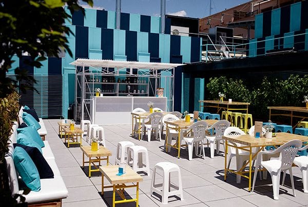 Vibrant outdoor terrace at La Casa Encendida for summer events and gatherings.