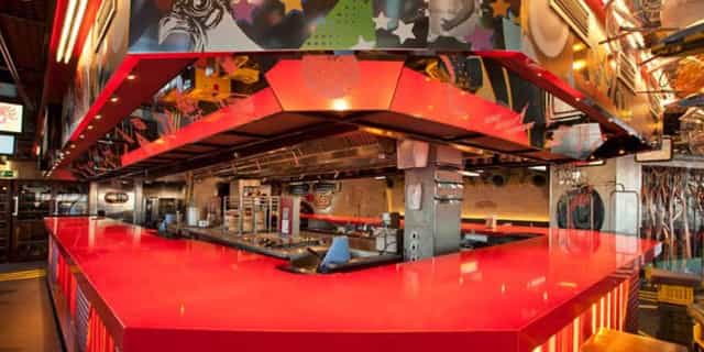 Private room in StreetXO: vibrant modern kitchen for culinary events and interactive classes.