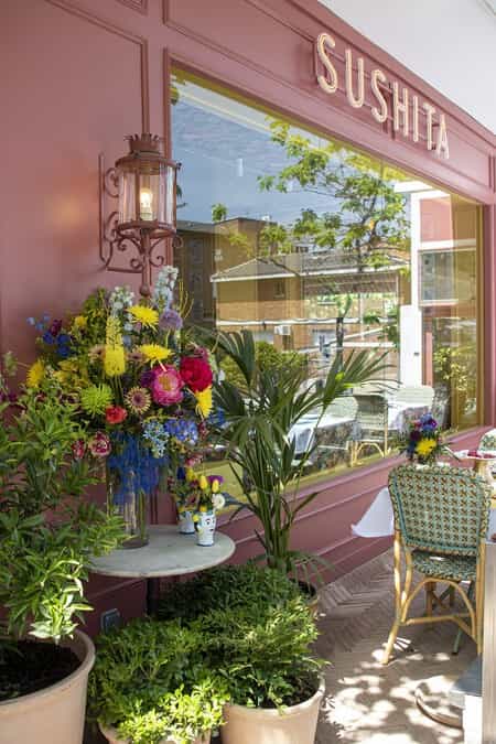 Elegant floral arrangement at La Madonna Sushita entrance for memorable events.