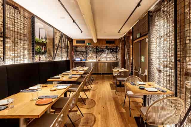 Stylish restaurant with wooden tables for private dining and networking events.