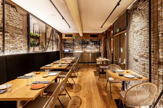 Stylish restaurant with wooden tables for private dining and networking events.