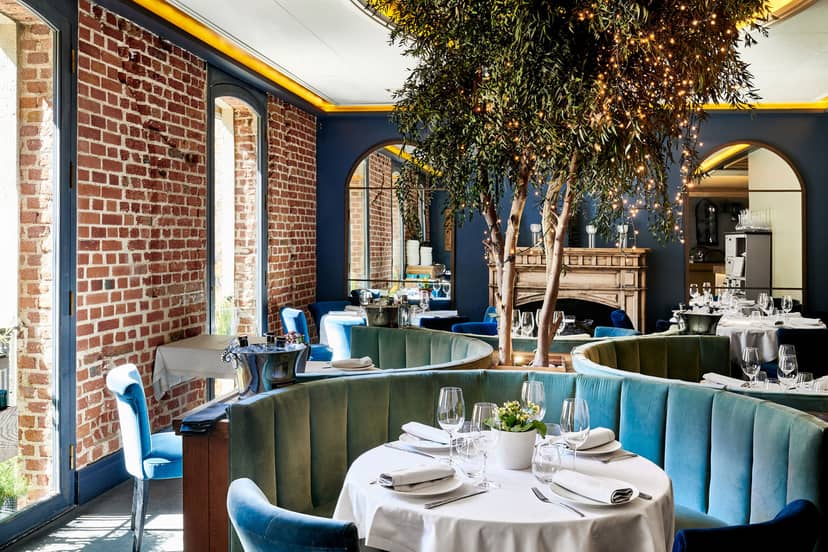 Stylish restaurant dining space with emerald seating, ideal for upscale events and gatherings.
