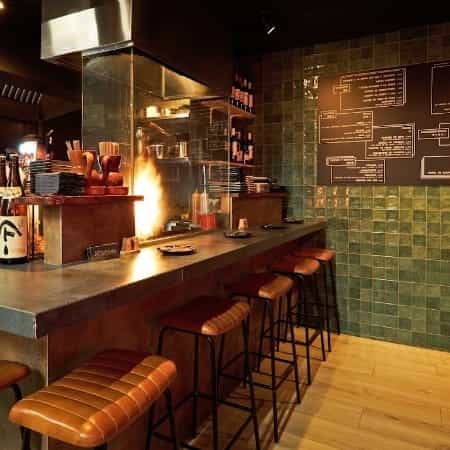 Stylish Japanese restaurant kitchen with bar seating, ideal for culinary events and workshops.
