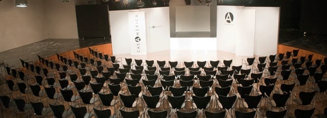Gabriela Mistral Amphitheatre: spacious corporate event venue with theater seating and large screen.