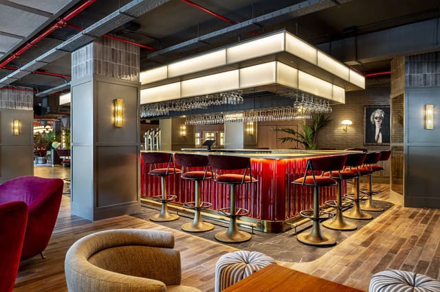Stylish bar area in Radisson RED Madrid for networking and events.