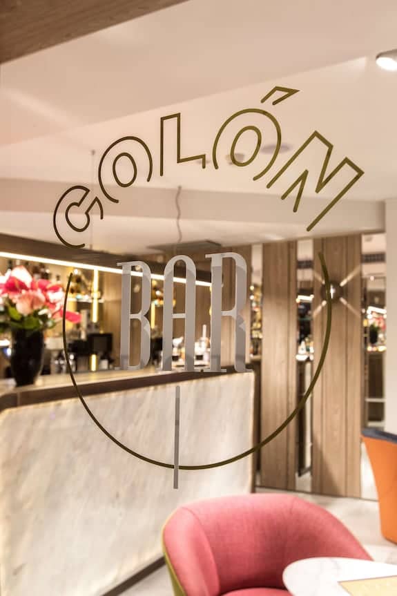Stylish bar entrance at NH Collection Madrid Colón for networking events and gatherings.