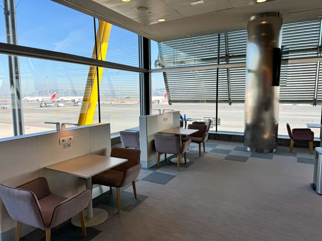 Modern airport lounge at Crowne Plaza Madrid, ideal for pre-event meetings and networking.