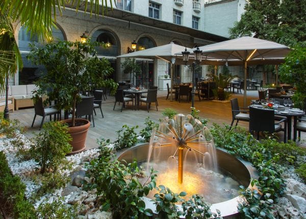 Elegant outdoor garden venue with lush greenery, ideal for receptions and gatherings.