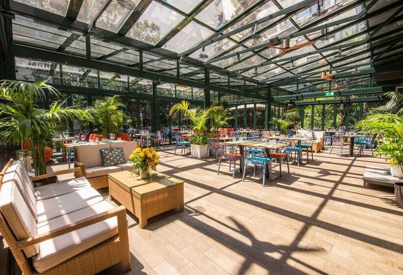 Outdoor garden venue with glass panels, perfect for elegant events and gatherings.