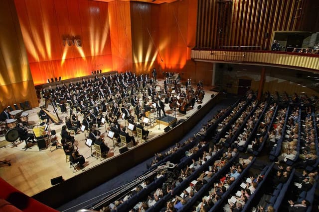 Teatro Monumental concert hall with vibrant audience awaiting orchestra performance.
