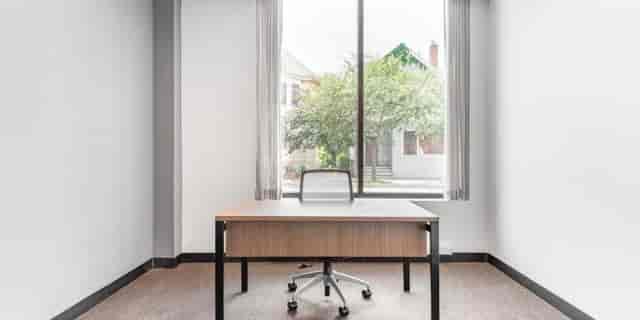 Minimalist virtual office meeting space with natural light for productive brainstorming sessions.