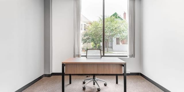 Minimalist virtual office meeting space with natural light for productive brainstorming sessions.