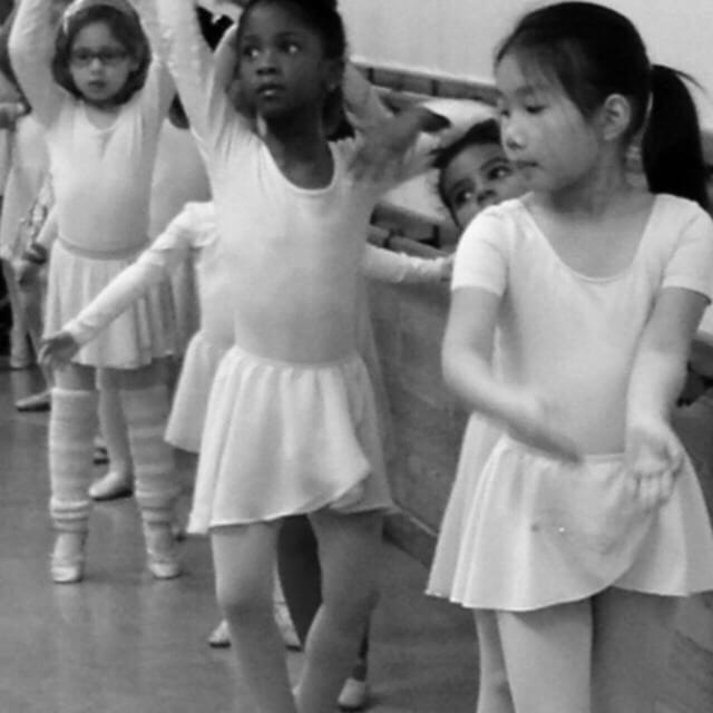 Young dancers practicing ballet at an American Dance & Drama Studio event.