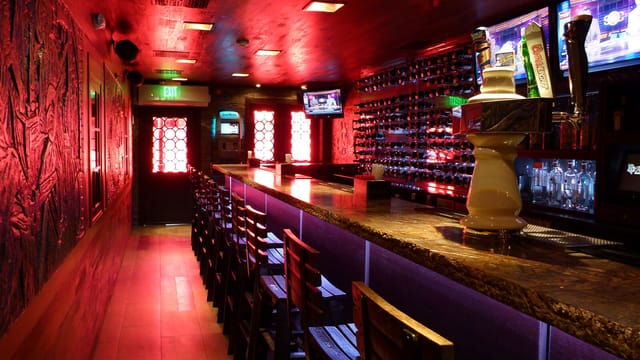 Sleek bar at Adega Grill, ideal for intimate gatherings and networking events.