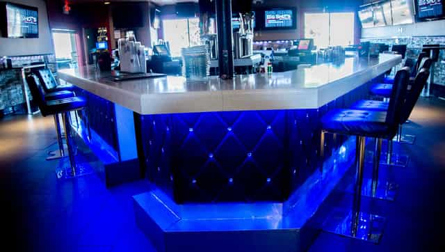 Modern bar with blue lighting at Big Shots Restaurant, ideal for networking events.